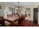 Formal dining room featuring a large table, chandelier, and views of the outdoors at 204 Oak Lake Dr, Spring Hill, FL 34608