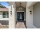 Inviting home entryway featuring brick columns and a glass-paneled door with sidelights and an overhead light at 204 Oak Lake Dr, Spring Hill, FL 34608