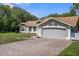 Charming single-story home with a well-maintained yard and a spacious two-car garage at 204 Oak Lake Dr, Spring Hill, FL 34608