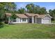 Charming single-story home featuring a two-car garage and landscaped front yard at 204 Oak Lake Dr, Spring Hill, FL 34608
