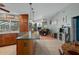 Open-concept kitchen with breakfast bar, wood cabinets, and seamless flow into the living area at 204 Oak Lake Dr, Spring Hill, FL 34608