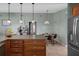 Open kitchen view complete with stainless steel refrigerator and eat-in dining area at 204 Oak Lake Dr, Spring Hill, FL 34608