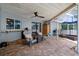 An outdoor lanai featuring two sitting areas, an outdoor grilling station, and lovely brick pavers at 204 Oak Lake Dr, Spring Hill, FL 34608