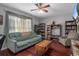 Inviting living room with wood floors, comfortable seating, and large window for natural light at 204 Oak Lake Dr, Spring Hill, FL 34608