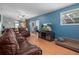 Spacious living room with comfortable leather seating and sliding glass doors to the outdoors at 204 Oak Lake Dr, Spring Hill, FL 34608