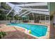 Inviting screened-in pool area with a refreshing pool, lounge furniture, and a playful inflatable toy at 204 Oak Lake Dr, Spring Hill, FL 34608