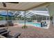 Relaxing screened-in pool with inviting lounge furniture, and a playful inflatable at 204 Oak Lake Dr, Spring Hill, FL 34608