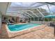 A spacious screened-in pool featuring a playful inflatable shark and ample seating at 204 Oak Lake Dr, Spring Hill, FL 34608