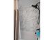 Shower in tub/shower combination with modern, marble-look tile and bronze hardware at 204 Oak Lake Dr, Spring Hill, FL 34608