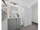 Bright bathroom with gray vanity, modern lighting, storage, and linen closet at 2326 Auburn S St, St Petersburg, FL 33712
