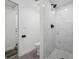 Bathroom with walk-in shower featuring marble tile, modern fixtures, and neutral tones at 2326 Auburn S St, St Petersburg, FL 33712