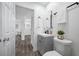 Charming bathroom with gray vanity, modern fixtures, and views to the hallway and living room at 2326 Auburn S St, St Petersburg, FL 33712