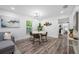 Modern dining area featuring a stylish table, contemporary lighting, and seamless flow into the living space and kitchen at 2326 Auburn S St, St Petersburg, FL 33712