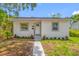 Inviting single-story home featuring a fresh exterior, complemented by a tidy walkway and manicured front garden at 2326 Auburn S St, St Petersburg, FL 33712
