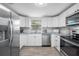 Bright kitchen features stainless steel appliances, granite countertops, and white cabinets at 2326 Auburn S St, St Petersburg, FL 33712