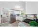 Open-concept kitchen boasts stainless steel appliances, granite countertops, and adjacent living space at 2326 Auburn S St, St Petersburg, FL 33712