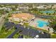 Aerial view showcases the community center with a pool, tennis courts, and ample parking at 2330 Ecuadorian Way # 30, Clearwater, FL 33763