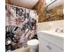 A bathroom featuring a patterned shower curtain, and a white sink and toilet at 2330 Ecuadorian Way # 30, Clearwater, FL 33763