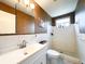 Bathroom featuring white tile walls, a mosaic tile shower floor and decorative wallpaper at 2330 Ecuadorian Way # 30, Clearwater, FL 33763