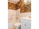 Neutral bathroom featuring a bathtub with handrails, and tropical wallpaper at 2330 Ecuadorian Way # 30, Clearwater, FL 33763