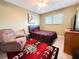 Bedroom offering a comfortable bed, accent chair, and a soothing color palette at 2330 Ecuadorian Way # 30, Clearwater, FL 33763