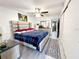 Bright bedroom featuring a ceiling fan, wood-look floors, and a plaid duvet at 2330 Ecuadorian Way # 30, Clearwater, FL 33763