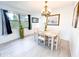 Cozy dining area featuring a wooden table set, a chandelier, and a bright window with natural light at 2330 Ecuadorian Way # 30, Clearwater, FL 33763