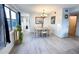 Bright dining area with a modern table set, a chandelier, and a large window offering a pleasant view at 2330 Ecuadorian Way # 30, Clearwater, FL 33763