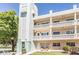 Aloha building exterior shows white siding, balconies, and decorative architectural details at 2330 Ecuadorian Way # 30, Clearwater, FL 33763