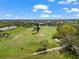 Scenic aerial of the golf course with lush greenery and mature trees under a blue sky at 2330 Ecuadorian Way # 30, Clearwater, FL 33763