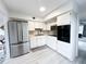 Modern kitchen features white cabinetry, stainless steel appliances, and an open layout at 2330 Ecuadorian Way # 30, Clearwater, FL 33763