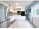 A modern kitchen with an oven and microwave combo, refrigerator, sink, and white cabinets at 2330 Ecuadorian Way # 30, Clearwater, FL 33763