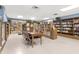 Inviting library space with shelves of books, a table, and comfortable seating at 2330 Ecuadorian Way # 30, Clearwater, FL 33763