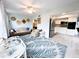 Cozy living area with stylish furniture, a ceiling fan, and an open layout to the kitchen, perfect for entertaining at 2330 Ecuadorian Way # 30, Clearwater, FL 33763