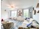 Living room with a ceiling fan, decorative rug, couch, and windows at 2330 Ecuadorian Way # 30, Clearwater, FL 33763