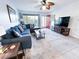 Bright living room with comfortable seating, stylish decor, and a large window that lets in plenty of natural light at 2330 Ecuadorian Way # 30, Clearwater, FL 33763