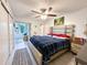 Serene primary bedroom with a comfortable bed, a ceiling fan, and access to a sunroom with plenty of natural light at 2330 Ecuadorian Way # 30, Clearwater, FL 33763