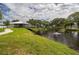 A scenic pond view with a gazebo, lush green grass, and trees at 2330 Ecuadorian Way # 30, Clearwater, FL 33763
