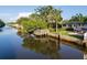 Stunning aerial view of a waterfront property with a private dock and meticulously landscaped yard, showcasing luxurious outdoor living at 243 45Th Ne Ave, St Petersburg, FL 33703