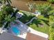 Breathtaking aerial view showcasing a waterfront property with a pool, fire pit, and lush landscaping at 243 45Th Ne Ave, St Petersburg, FL 33703