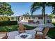 Spacious backyard with a cozy fire pit area, comfortable seating, and lush landscaping, perfect for outdoor relaxation at 243 45Th Ne Ave, St Petersburg, FL 33703