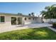 Backyard with a pool, a brick patio, a well-manicured lawn and palm trees at 243 45Th Ne Ave, St Petersburg, FL 33703