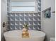 Bright bathroom featuring a freestanding tub, tiled walls, and a built-in shelf at 243 45Th Ne Ave, St Petersburg, FL 33703