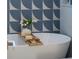 Close up of the bathroom featuring a freestanding tub with a bamboo tray and blue tile at 243 45Th Ne Ave, St Petersburg, FL 33703