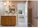 Modern bathroom boasts a double vanity, stylish mirrors, and easy access to an adjacent space at 243 45Th Ne Ave, St Petersburg, FL 33703