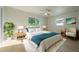 Well-lit bedroom featuring light wood-look floors, a ceiling fan, and ample decor at 243 45Th Ne Ave, St Petersburg, FL 33703