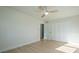 Bright bedroom with a ceiling fan, light wood-look floors, and a double door closet at 243 45Th Ne Ave, St Petersburg, FL 33703