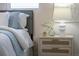 Bedroom nightstand featuring elegant decor, a stylish lamp, and natural light by the bedside at 243 45Th Ne Ave, St Petersburg, FL 33703