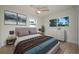 Comfortable bedroom with a ceiling fan, wood-look floors, and ample natural light at 243 45Th Ne Ave, St Petersburg, FL 33703