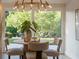 Bright dining room with a modern chandelier and views of the lush backyard at 243 45Th Ne Ave, St Petersburg, FL 33703